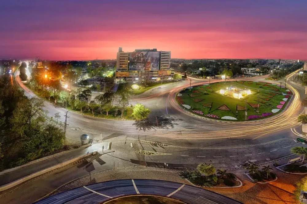 A Lahore boulevard and roundabout at dusk